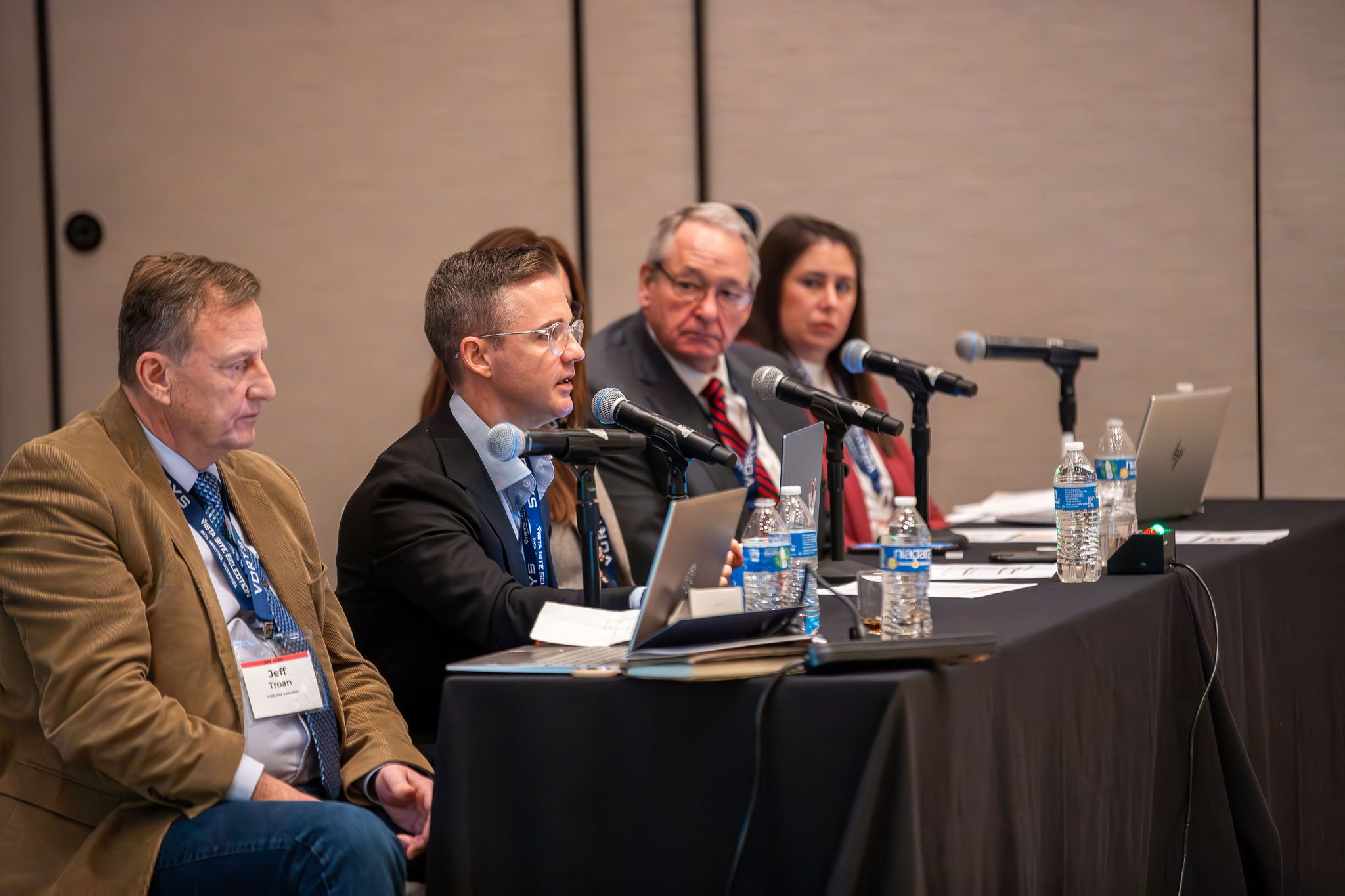 Jeff Troan (left), Chris Magill (second from left) and Julie Miller (right) present during a session on manufacturing site selection.